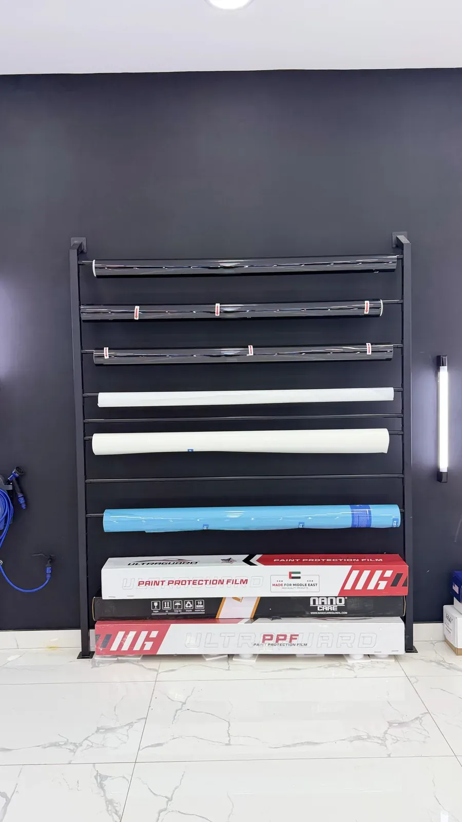 The film rack with paint protection film and tint rolls in stock