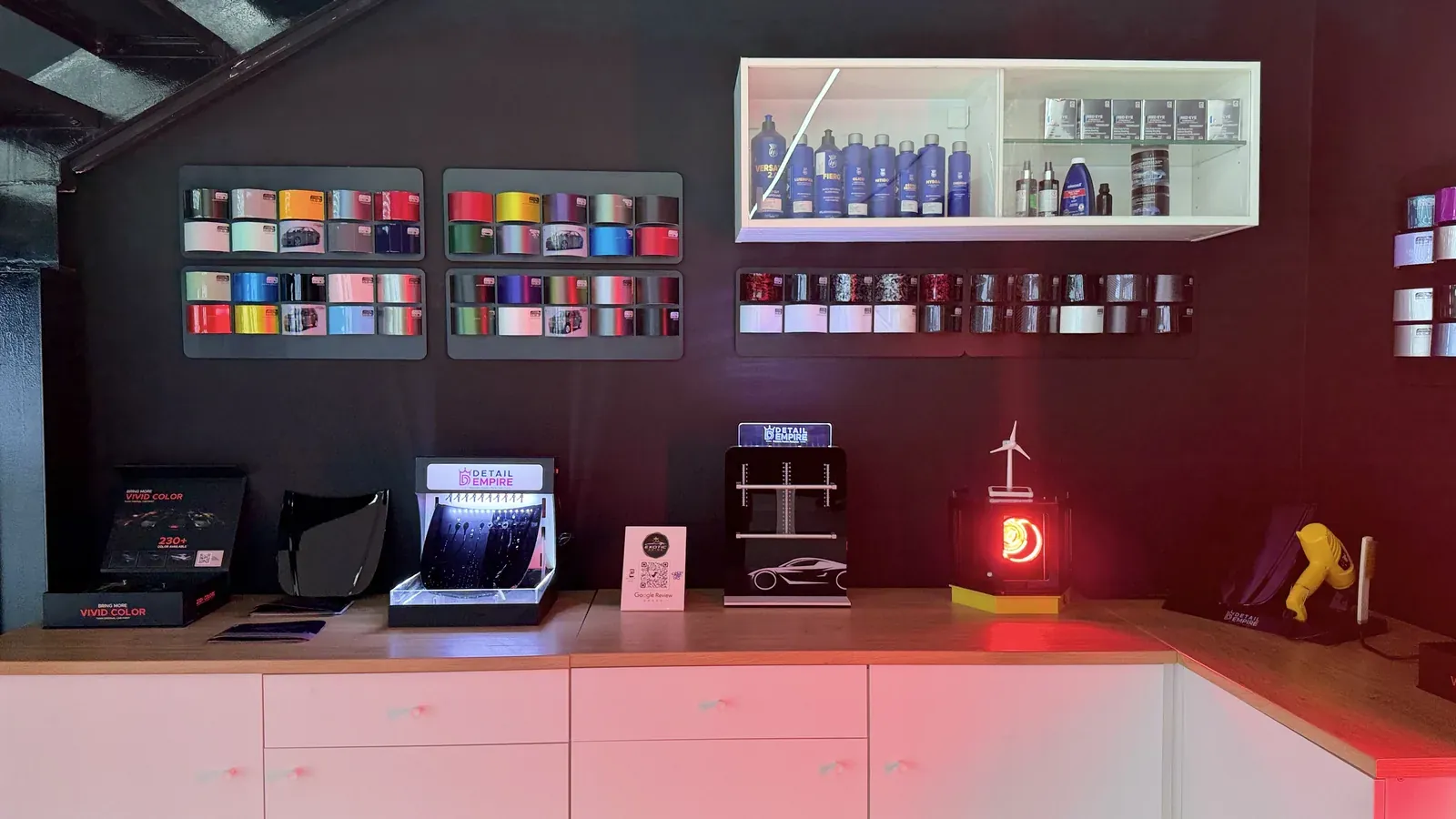 Wrap film and tint swatches on the counter, showing the colour range
